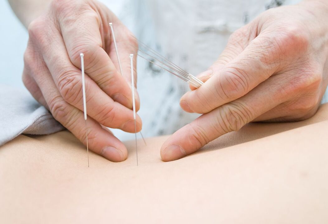 The doctor puts the needle